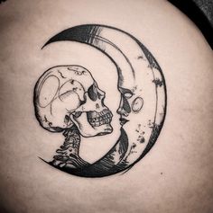 a black and white image of a skull sitting on the crescent with a moon behind it