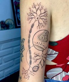 a woman's arm with a tree and moon tattoo on the left side of her arm