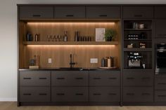 a kitchen with wooden cabinets and black counter tops, along with an oven in the center