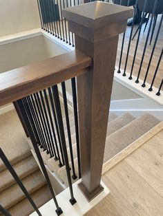 an image of a stair case in a house with wood and metal handrails