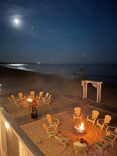 an outdoor fire pit on the beach at night