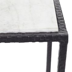 a black and white marble top side table with metal legs, on an isolated white background