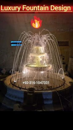 a large fountain is lit up at night