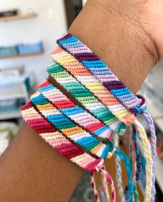 multicolored bracelets are stacked on top of each other