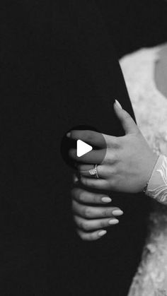 a man and woman standing next to each other with their hands on the bride's arm