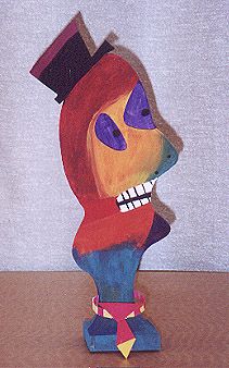 a wooden sculpture of a clown wearing a top hat