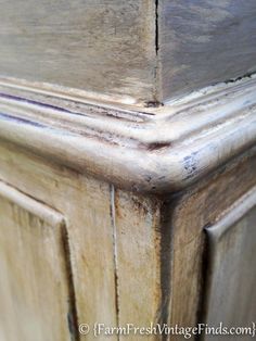 an old wooden cabinet with peeling paint on the top and bottom part of it's doors