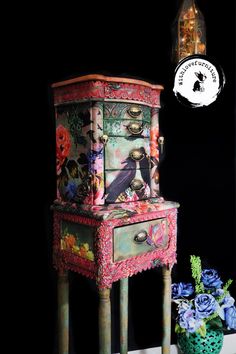 an old dresser has been painted with flowers and birds on it, as well as a vase