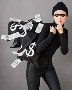 a woman in black with money bags on her back and the words $ 8 printed on it