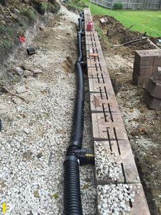 a large pipe laying on top of a pile of rocks