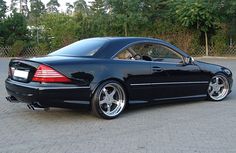 a black mercedes cls parked in a parking lot