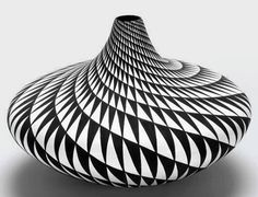 a black and white vase sitting on top of a table