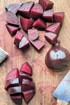 chopped up beets on a cutting board next to a knife