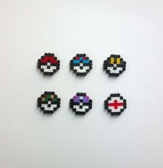 six different types of pacman bead badges on a white surface with one red, one blue and one black