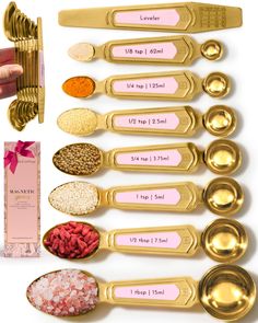 gold measuring spoons with pink labels on them next to each other and various types of measuring spoons