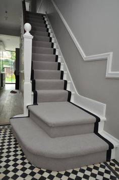 a set of stairs with black and white carpet