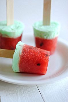 watermelon popsicles on a white plate with toothpicks