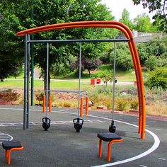 an empty basketball court with benches and swings