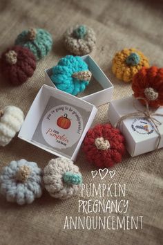 there are crocheted pumpkins and boxes on the table