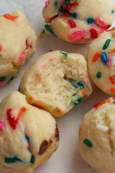 some colorful sprinkles on top of white doughnuts