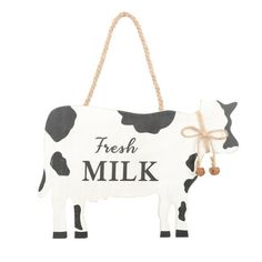 a wooden sign that says fresh milk with a cow on it