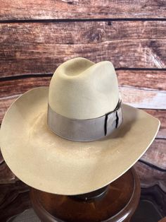 Vintage Stetson 4X Beaver Western Hat - Size 7 1/4, distressed.  ### Full Description: Step into timeless Western style with this vintage Stetson 4X Beaver felt hat. Made from a high-quality beaver blend, this hat showcases the craftsmanship and durability that Stetson is known for. The light tan color adds a classic touch, perfect for any Western or vintage enthusiast.  This hat features a wide brim and a traditional pinched crown, complemented by a matching grosgrain ribbon band with a stylish bow, enhancing its elegance. The inside of the hat is lined with a satin finish, bearing the iconic Stetson logo, and the leather sweatband ensures a comfortable fit.  This Stetson 4X Beaver hat is in excellent vintage condition, showing minimal signs of wear and preserving its shape and color beau Beaver Hat, Western Hat, Western Hats, Felt Hat, Light Tan, Tan Color, Western Style, Hat Sizes, Grosgrain Ribbon