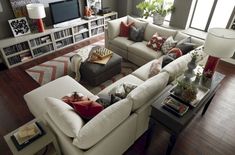 a living room filled with lots of white furniture