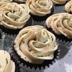 cupcakes with white frosting and green sprinkles