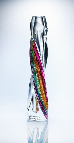 a colorful glass vase sitting on top of a table