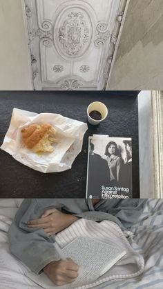 there is a coffee cup, book and pastry on the bed