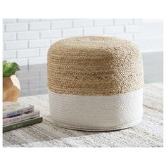 a white and beige ottoman sitting on top of a rug