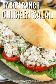 a chicken salad sandwich on a bun with lettuce and tomatoes