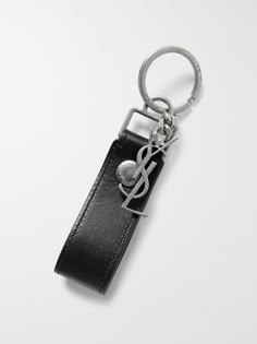 a black leather keychain with a metal treble on the front and back