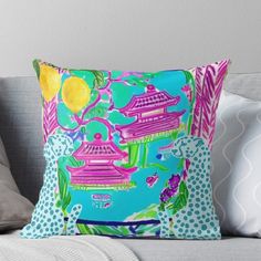 a blue and pink pillow on a couch