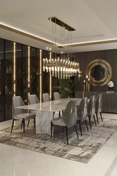 an elegant dining room with marble table and chairs, chandelier and large mirror on the wall