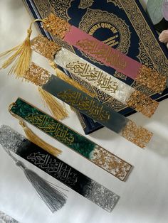 arabic calligraphy and tassels laid out on a table