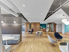 an office with wooden floors and white walls