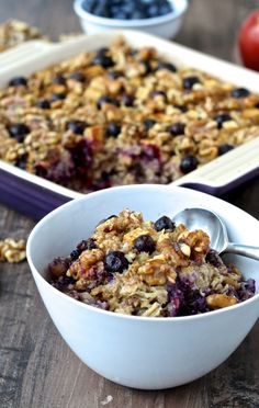 blueberry baked oatmeal in a white bowl with spoons next to it