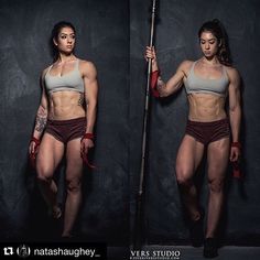 a woman with no shirt on holding a pole and posing for the camera in front of a black background