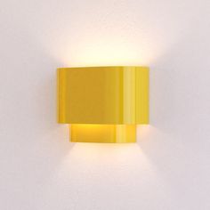 a yellow wall light mounted on the side of a white wall