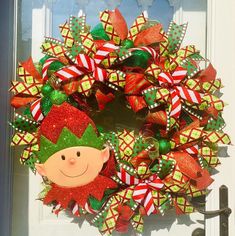 a christmas wreath with an elf's face on it