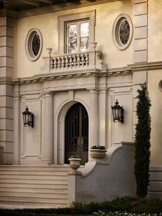 the front entrance to a large white house