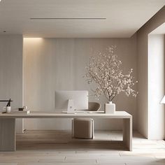 a white table with vases and a computer on it in a room that has wood flooring