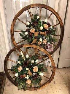 an old spinning wheel with flowers on the top and bottom is sitting in front of a door