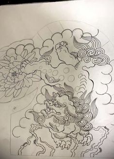 a drawing of a dragon and flowers on paper