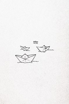 three origami boats floating on top of each other in the water with one boat flying above them