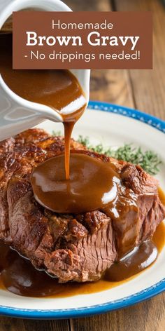 someone pouring gravy onto some meat on a plate