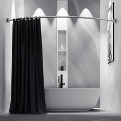 a white bath tub sitting next to a black curtain