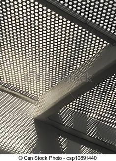 the ceiling in an office building with perfored metal mesh covering it's roof