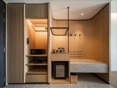 a bed sitting next to a wooden shelf in a bedroom